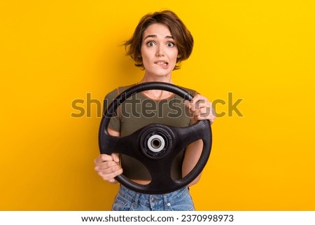 Photo of nervous woman wear trendy t-shirt hold steering wheel biting lips staring at accident isolated on yellow color background