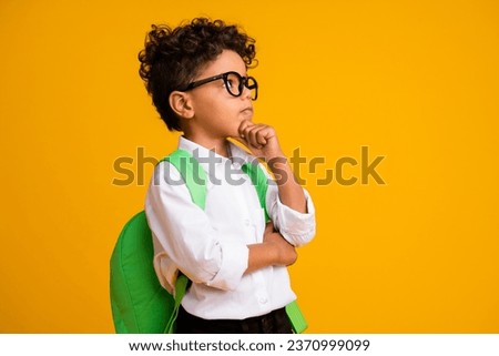 Profile photo of creative minded boy arm touch chin look empty space brainstorming isolated on yellow color background