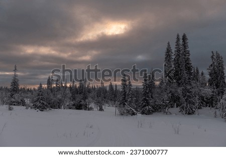 Sunrise shining through clouds on a winter morning in scandinavia
