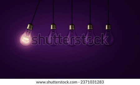 Creative light bulb lights up other extinguished light bulbs on a dark purple background, concept.  Leadership, creative idea. Think differently. Start up