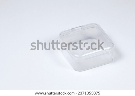 Empty small transparent plastic box isolated on white background. Royalty-Free Stock Photo #2371053075