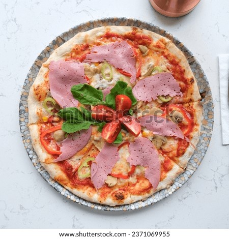 pizza with ham and arugula tomatoes
