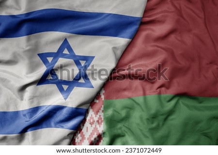 big waving national colorful flag of israel and national flag of belarus . macro