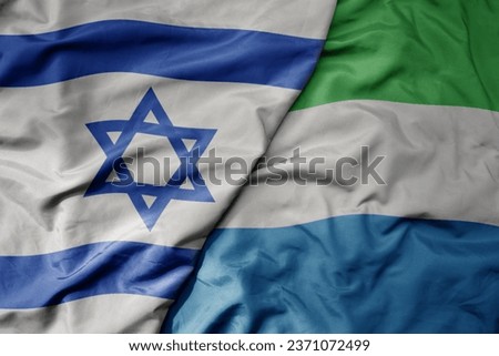 big waving national colorful flag of israel and national flag of sierra leone . macro