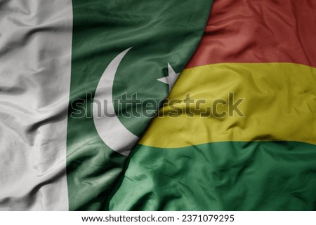 big waving realistic national colorful flag of pakistan and national flag of bolivia . macro