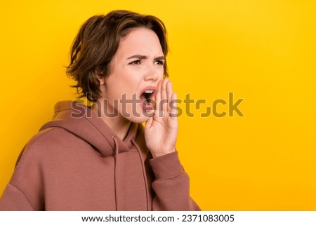 Portrait of girlish rude careless girl dressed brown sportswear blaming shouting look at empty space isolated on yellow color background Royalty-Free Stock Photo #2371083005