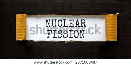 Nuclear fission symbol. Concept words Nuclear fission on beautiful white paper. Beautiful black paper background. Business science nuclear fission concept. Copy space. Royalty-Free Stock Photo #2371083487