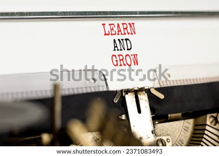 Learn and grow symbol. Concept word Learn And Grow typed on beautiful retro old typewriter. Beautiful white paper background. Business, education learn and grow concept. Copy space.