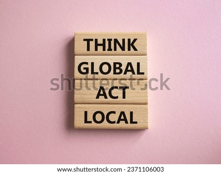 Think global act local symbol. Wooden blocks with words Think global act local. Beautiful pink background. Business and Think global act local concept. Copy space.