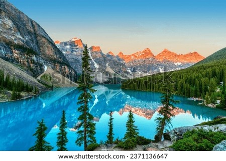 Golden sunrise over the Valley of the Ten Peaks with glacier-fed turquoise-colored Moraine Lake in the foreground near Lake Louise in the Canadian Rockies of Banff National Park. Royalty-Free Stock Photo #2371136647