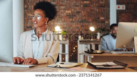 Business woman, office and computer for night marketing, social media management and editing online information. Professional african writer, editor or worker typing on desktop of copywriting project