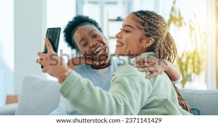 Selfie, funny and women with internet, hug and social media with a smartphone, connection and post. People, apartment or friends in a living room, facial expression and home with fun, silly and goofy Royalty-Free Stock Photo #2371141429