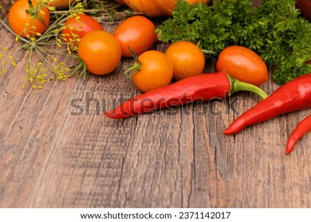 Hot peppers, pumpkins, tomatoes and parsley on the table. Autumn vegetables. Cooking. High quality photo