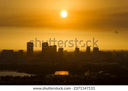 Aerial view of downtown district of Tampa city in Florida, USA at sunset. Dark silhouette of high skyscraper office buildings in modern american midtown