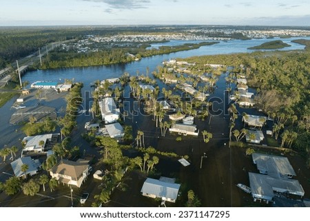 Aftermath of natural disaster. Surrounded by hurricane rainfall flood waters homes in Florida residential area Royalty-Free Stock Photo #2371147295