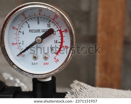 Outdoor residential weather resistance water filter pressure meter. Royalty-Free Stock Photo #2371151957