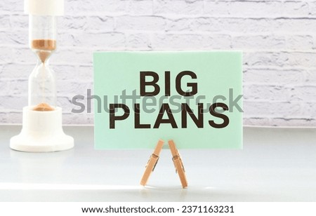 Business and finance concept. On a white background, there are red pencils, gears and a notebook with the inscription - BIG PLANS