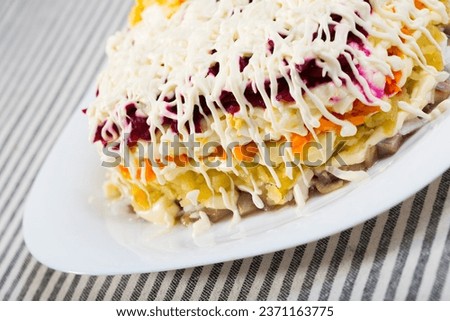 Photography of plate with Dressed herring is russian traditional dish in restaurante.