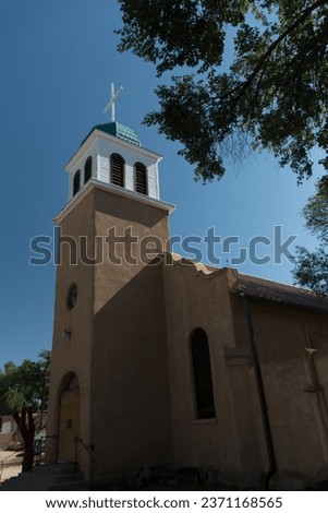 Looking up at cross and dome of St. Joseph's Church in Cerrillos town on Turquoise Trail in New Mexico Royalty-Free Stock Photo #2371168565