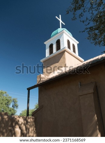 Looking up at cross and dome of St. Joseph's Church in Cerrillos town on Turquoise Trail in New Mexico Royalty-Free Stock Photo #2371168569