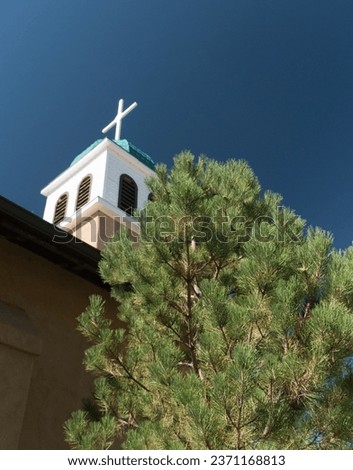 Looking up at cross and dome of St. Joseph's Church in Cerrillos town on Turquoise Trail in New Mexico Royalty-Free Stock Photo #2371168813
