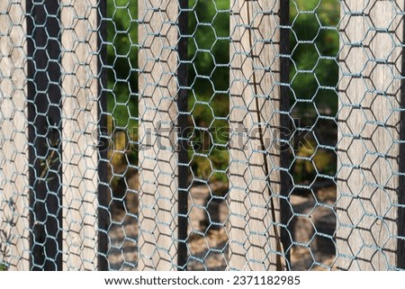 post and mesh wire fence in selective focus