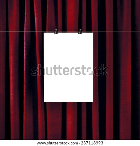 Poster on a background of red curtains.