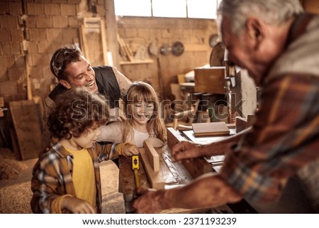 Young future carpenters learning the ways of their elders in a wood shop