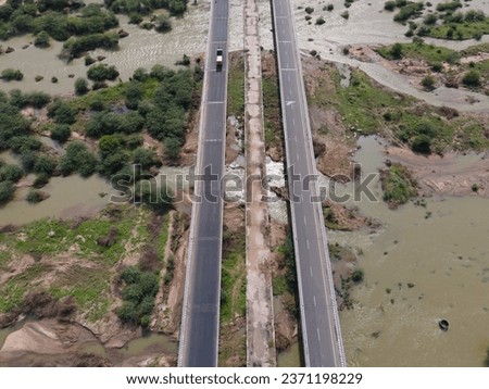 drone shot aerial view top angle panoramic photograph of highway bridge asphalt road freeway motorway passing over flooded fast flowing river stream wallpaper india tamilnadu transportation tropical 