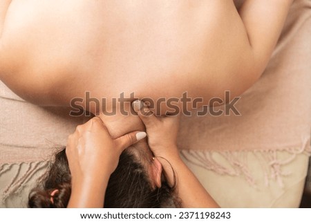 Top view close-up photo of a woman receiving a professional back massage in a beauty salon