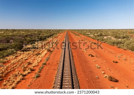 Train tracks through the red centre of outback Australia Royalty-Free Stock Photo #2371200043