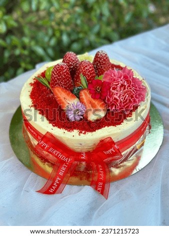 Delicious Strawberry cream cheese cake for happy Birth Day party. 
cheesecake on a wooden plate. Fresh  Strawberry topping with cream and thyme leaves. Bakery picture free space for text.