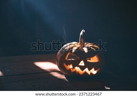 Jack O' Lantern glowing in smoky fantasy night. Halloween background