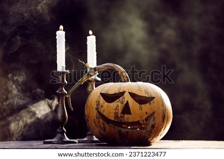 Jack O' Lantern glowing in smoky fantasy night. Halloween background