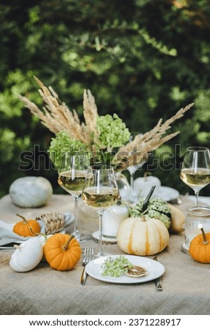 Fall decoration rustic style, cozy home atmosphere , candles, dry flowers. Autumn elegant beautiful table setting with pumpkins for a wedding or thanksgiving celebration. 