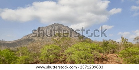 Girnar back side view from the front side hill from location Bhavnath nearabout Kashmiri Bapu Ashram. Royalty-Free Stock Photo #2371239883