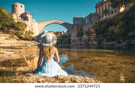Woman in white dress looking at Old bridge in Town of Mostar- Bosnia Herzegovina Royalty-Free Stock Photo #2371244721