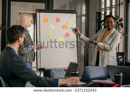 Inclusive corporate culture on display as a varied group of professionals in a conference room, exchanging insights during a collaborative meeting