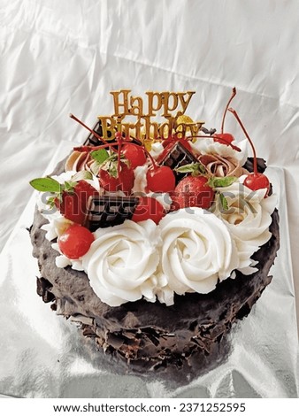 Beautiful birthday cake for women. Decorated with fresh strawberry, chocolate and cream frosting. isolated white. close up.
