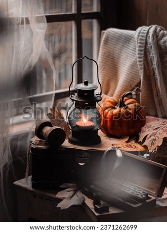 Mini lantern besides the window. Conceptual stillife photography.  Selective focus