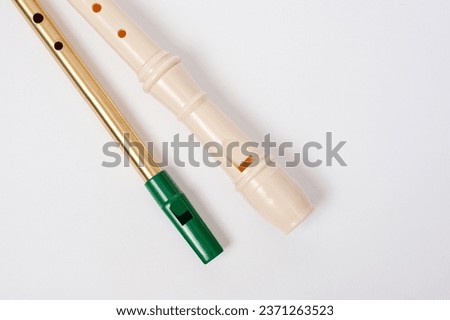 Irish whistle and block flute are longitudinal flutes with a whistle device and playing holes. Royalty-Free Stock Photo #2371263523
