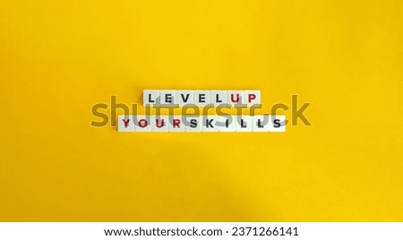 Level Up Your Skills Phrase and Concept Image.
Letter Tiles on Yellow Background. Minimal Aesthetic.