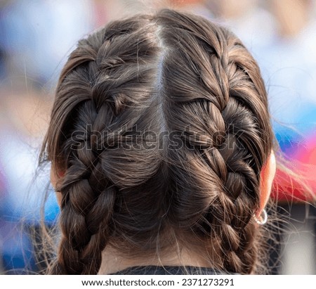 Close-up of braids on a girl's head. Royalty-Free Stock Photo #2371273291