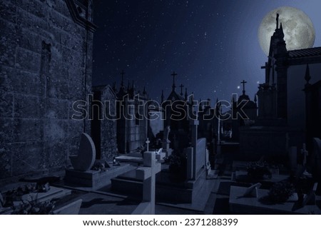 Old european cemetery in a starry full moon night 
