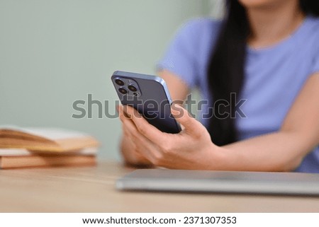 Woman hand typing massage, checking social med on mobile phone. Technology and communicating concept. Royalty-Free Stock Photo #2371307353