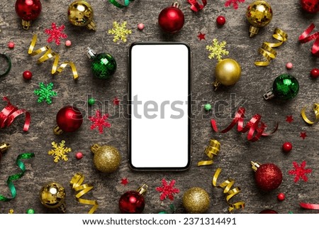 Christmas online shopping from home phone with blank white display top view. smart mobile with copy space on colored background with Christmas decorations balls,. Winter holidays sales background.