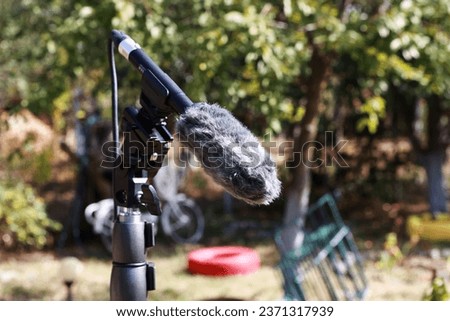Zoom microphone in natural setting in autumn garden.