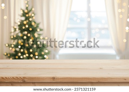 Desk space in front of window with Christmas tree background