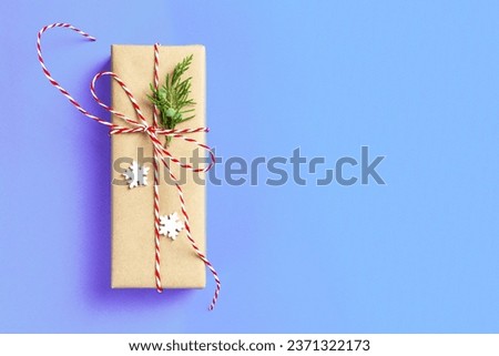 Christmas gift boxein front of blue background with copy space.