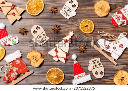 Top view of Christmas toys on wooden background. New Year ornament. Holiday concept.